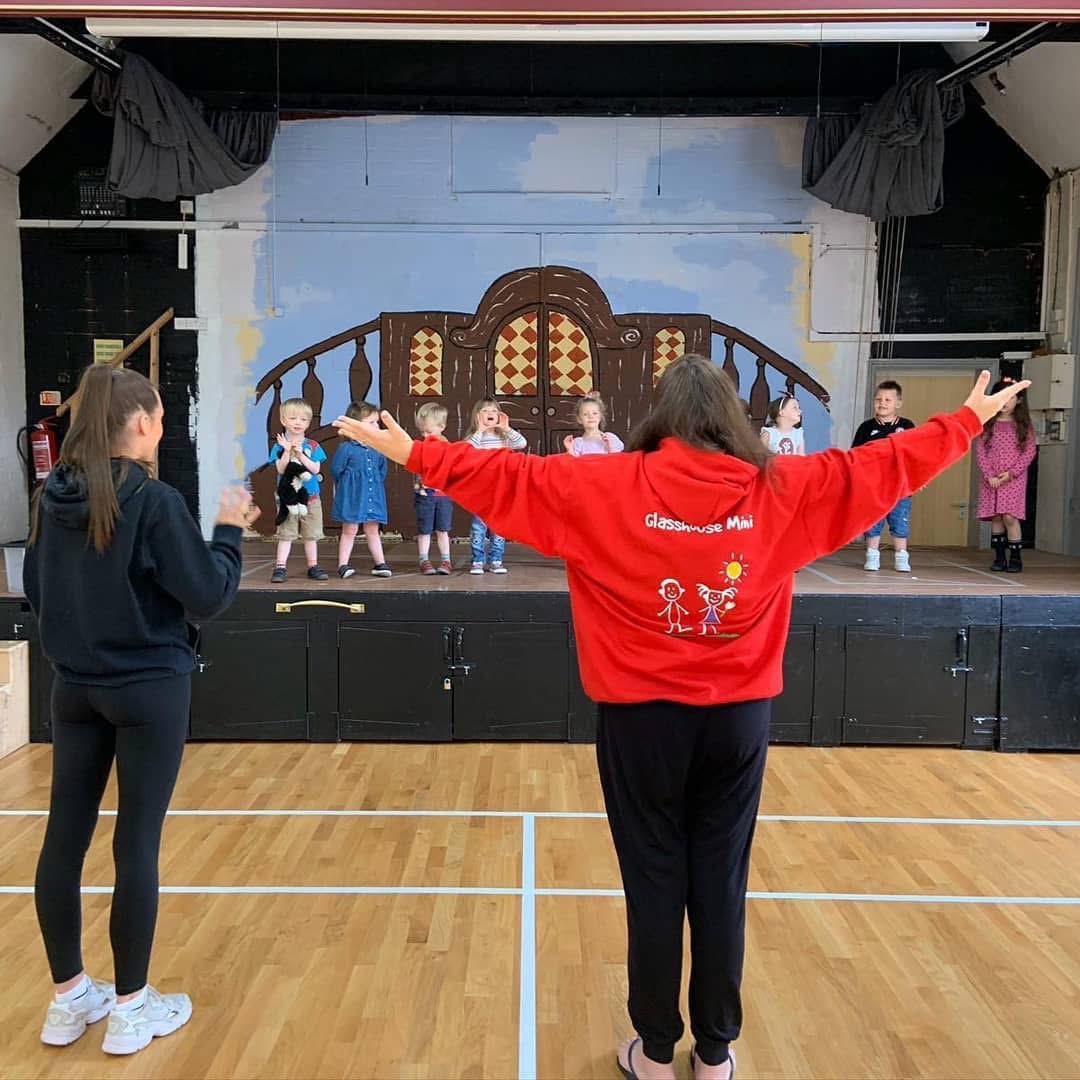 Amazing Amy Standing infront of the stage, the kids are all up on stage.